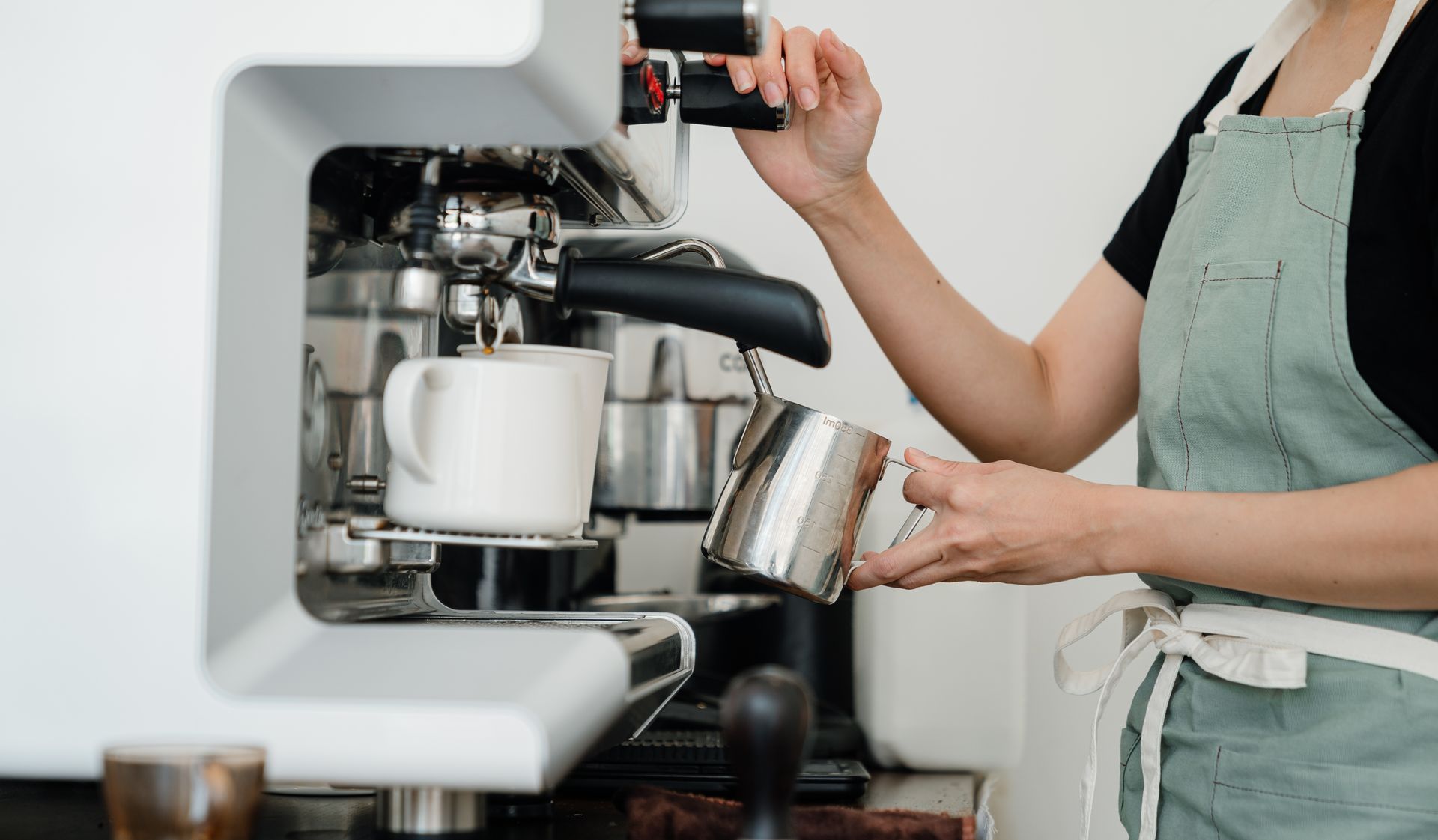 Espresso machine pulling a shot into two cups