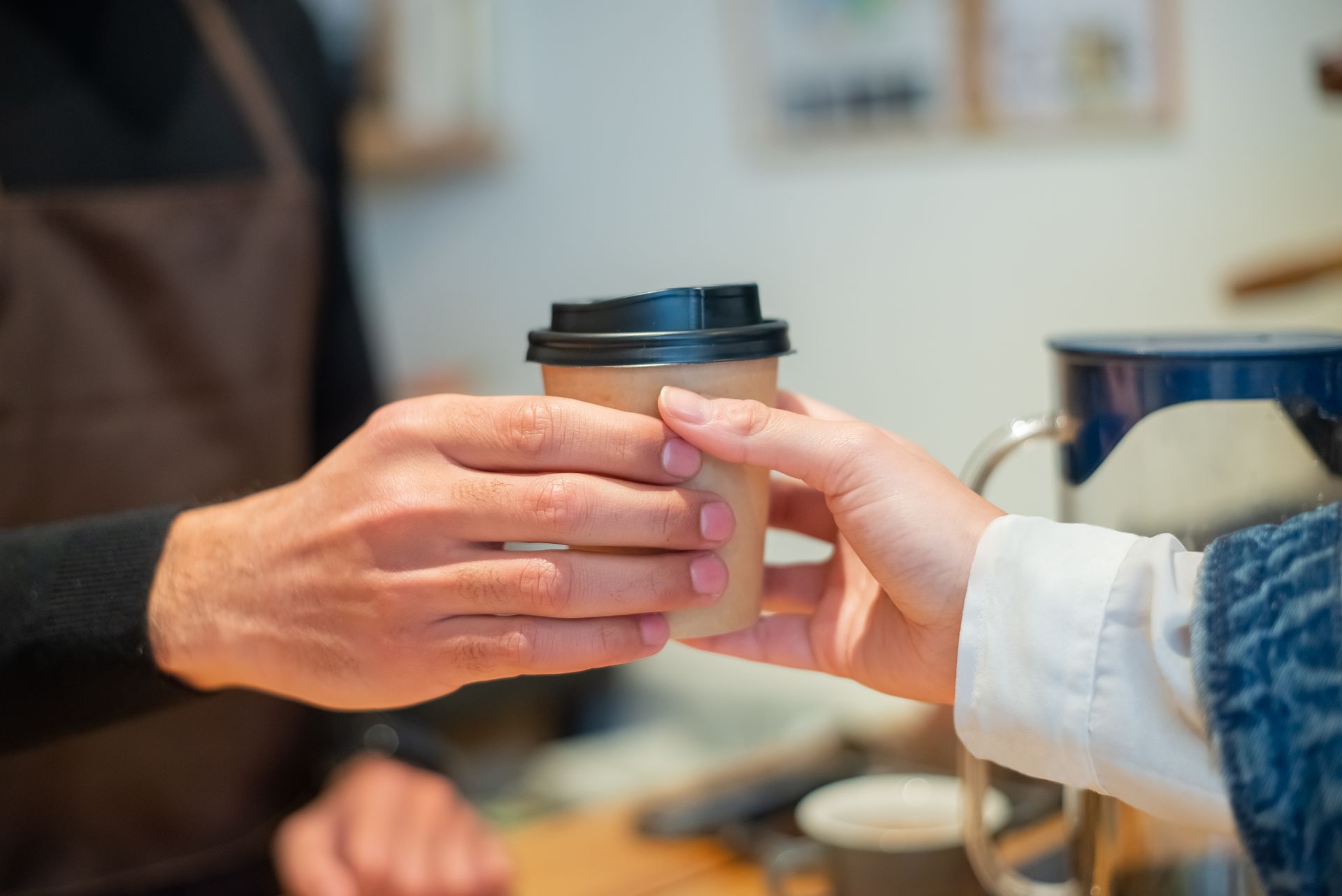 Coffee handed over the counter to a customer